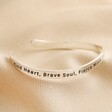 First Half of Adjustable Nana Meaningful Word Wave Bangle in Silver on Beige Fabric