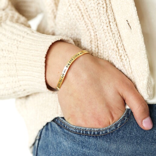 Model Wearing Bangle Adjustable 'Sisters' Meaningful Word Wave Bangle in Gold on model with hand in pocket