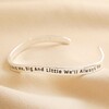 Alternate angle of Adjustable Sisters Meaningful Word Wave Bangle in Silver on Beige Fabric