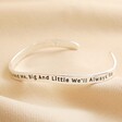 Alternate angle of Adjustable Sisters Meaningful Word Wave Bangle in Silver on Beige Fabric