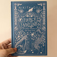 Model Holding Fierce Fairy Tales Book