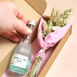 Model Holding Gin out of Gin Dried Flower Posy Letterbox Gift Packaging