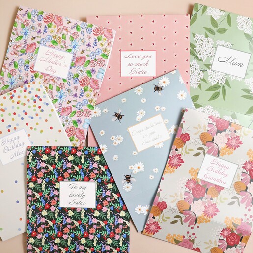 Colourful Kraft Gift Box with Personalised Sleeves laid out on a peach background