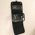 Stackers Black Hanging Travel Washbag Unfolded and Hung From Neutral Wall