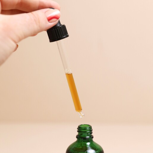 Model using dropper from the Norfolk Natural Living Indoor Plant Food