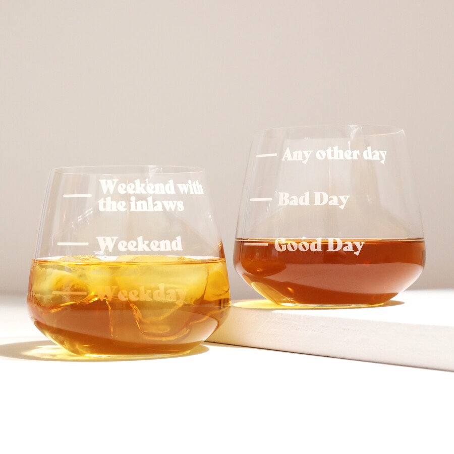 Personalised Measure Whisky Glasses against white backdrop with whisky inside