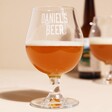 Personalised Name Beer Stemmed Beer Glass with Beer Inside in Front of Beer Bottle and Other Beer Glass