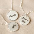Personalised Sterling Silver Hammered Disc Necklace on Beige Fabric