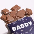 Broken Pieces of Best Daddy Salted Caramel Milk Chocolate Bar on White Surface
