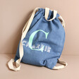 Personalised Initial Name BagBase Denim Drawstring Bag in front of natural coloured background