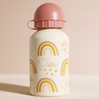 Back of Personalised Sass & Belle Kids' Earth Rainbow Metal Water Bottle Against Pink Background