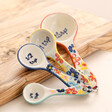 Sass & Belle Floral Measuring Spoons leaning on wooden board 