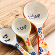 Close up of Sass & Belle Floral Measuring Spoons on wooden board