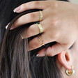 Model Wearing Adjustable Midnight Blue Enamel Sun Ring in Gold Stacked With Other Rings
