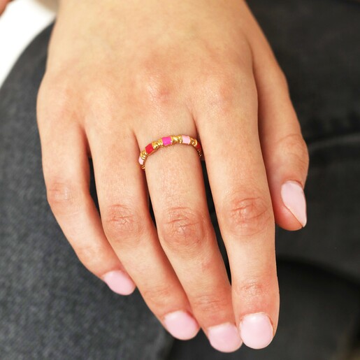 Model Wearing Adjustable Pink Enamel Twist Ring in Gold on black denim background