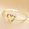 Adjustable Rainbow Crystal Heart Ring in Gold on Neutral Fabric