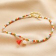 Colourful Pearl and Tassel Beaded Anklet in Gold on neutral fabric 