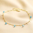 Semi-Precious Jade Stone Droplet Anklet in Gold on beige coloured fabric