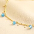 Close up of Semi-Precious Jade Stone Droplet Anklet in Gold on neutral coloured material