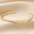 Adjustable Enamel Daisy Bangle in Gold on Neutral Fabric