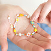Model holding Colourful Flower and Pearl Beaded Bracelet in palm of hand