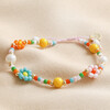 Full Colourful Flower and Pearl Beaded Bracelet on beige fabric