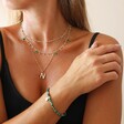 Model Wearing Green Semi-Precious Beaded Bracelet with Sun Charm in Gold With Other Jewellery Pieces