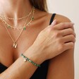 Model Wears Green Semi-Precious Beaded Bracelet with Sun Charm in Gold With Other Gold Jewellery