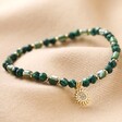 Green Semi-Precious Beaded Bracelet with Sun Charm in Gold on Neutral Fabric