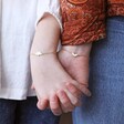 Daughter and Mother Models Wearing Mother & Child Set of 2 Flower Bracelets in Gold while Holding Hands