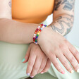 Pride Semi-Precious Beaded Bracelet in Pink on Model with Rainbow Version Stacked