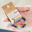 Model Holding Pride Semi-Precious Beaded Bracelet in Blue in Packaging