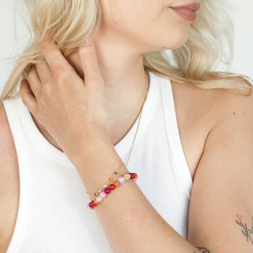 Model Wearing Pride Semi-Precious Beaded Bracelet in Pink with Hand in Hair