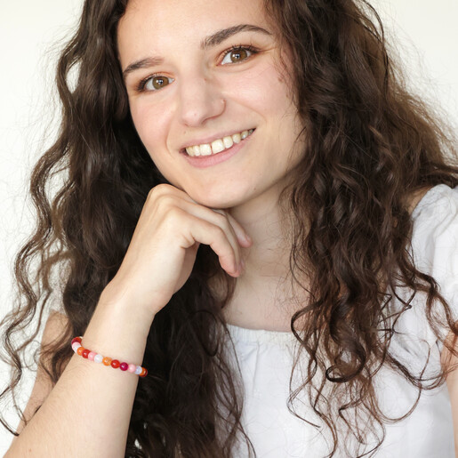 Model Smiling Wearing Pride Semi-Precious Beaded Bracelet in Pink
