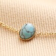 Close up of charm on Semi-Precious Turquoise Stone Bracelet in Gold