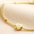 Close up of charm on Smiling Heart Face and Enamel Ball Chain Bracelet in Gold