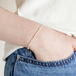 White Miyuki Bead and Freshwater Seed Pearl Bracelet on Model with hand in pocket