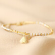 White Semi-Precious Stone Beaded Bracelet in Gold on Neutral Fabric
