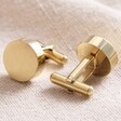 Brushed Finish Round Cufflinks in Gold Showing Toggle on Back on Beige Fabric