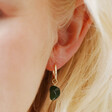 Close Up Photo of African Jade Stone Hoop Earrings in Gold on Model