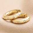 Chunky Crystal Hoop Earrings in Gold on Neutral Fabric
