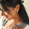 Model Smiling Wearing Cloisonné Hoop Earrings in Silver with Curated Ear