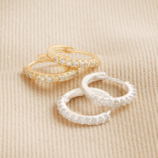 Also Available in Gold Crystal Huggie Hoops in Gold and Silver on Neutral Fabric