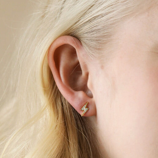 Model Wearing Crystal Lightning Bolt Stud Earrings in Gold