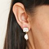 Close up of brunette model wearing Crystal Stud and Freshwater Pearl Drop Earrings in Gold