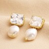 Crystal Stud and Freshwater Pearl Drop Earrings in Gold on beige fabric