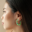 Side View of Model Wearing Dried Flower Resin Hoop Earrings in Green