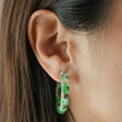 Close Up of Brunette Model Wearing Dried Flower Resin Hoop Earrings in Green