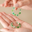 Model Holding Dried Flower Resin Hoop Earrings in Green