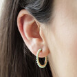 Close Up of Green Stone Hoop Earrings in Gold on Model